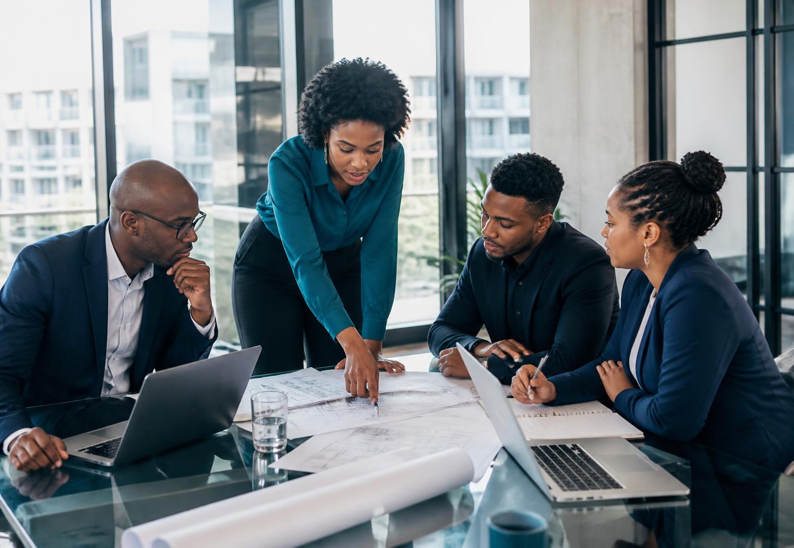 Consultants reviewing an architecture diagram with a client team in South Africa
